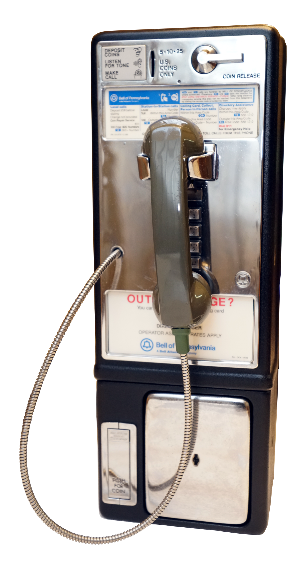A coin-operated public payphone mounted on a street in the United States
