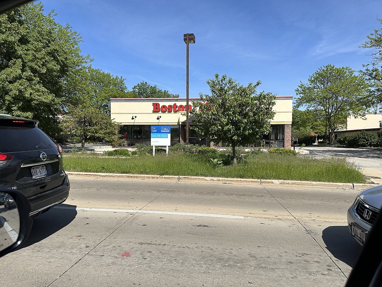A Boston Market restaurant storefront with the chain's logo above the entrance