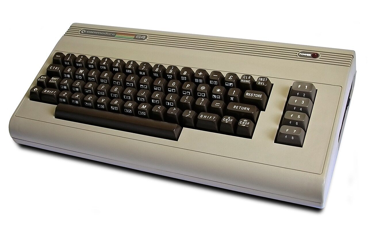 A Commodore 64 home computer shown from the front and the back