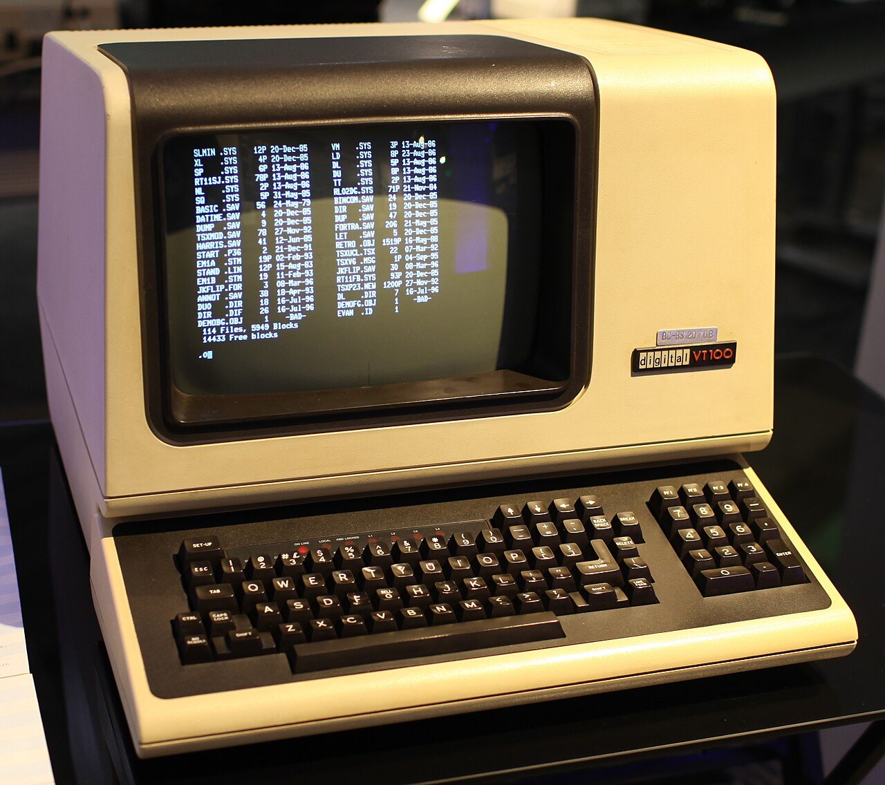 A DEC VT100 computer terminal with a green phosphor screen and keyboard