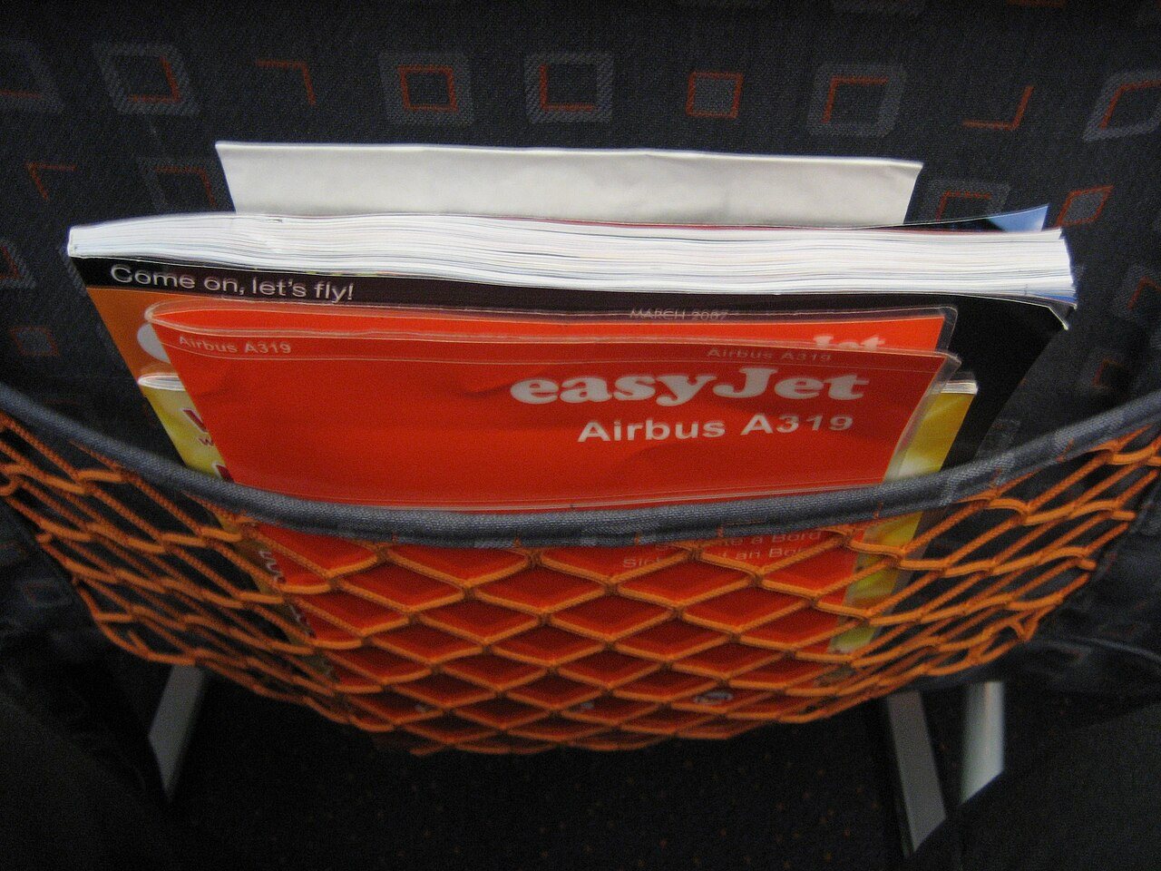 A SkyMall in-flight shopping catalog tucked into an airplane seat pocket