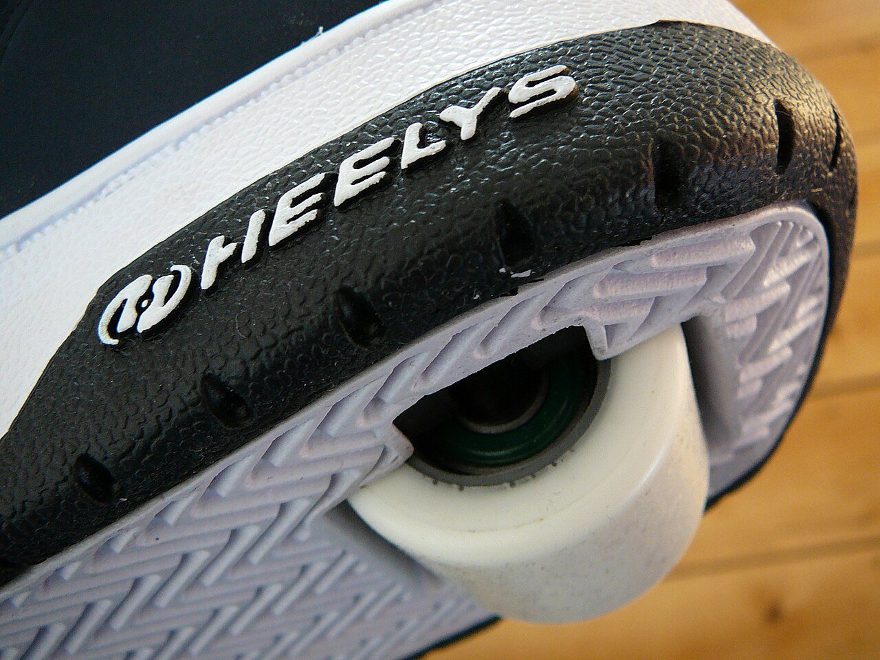 A sneaker with a small wheel set into the heel, the design sold as Heelys