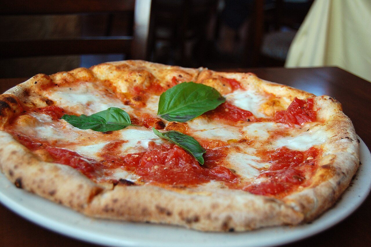 Pizza Margherita on a wooden board, an example of the kind of consumable retail category the dot-com era kept assuming the internet would unlock