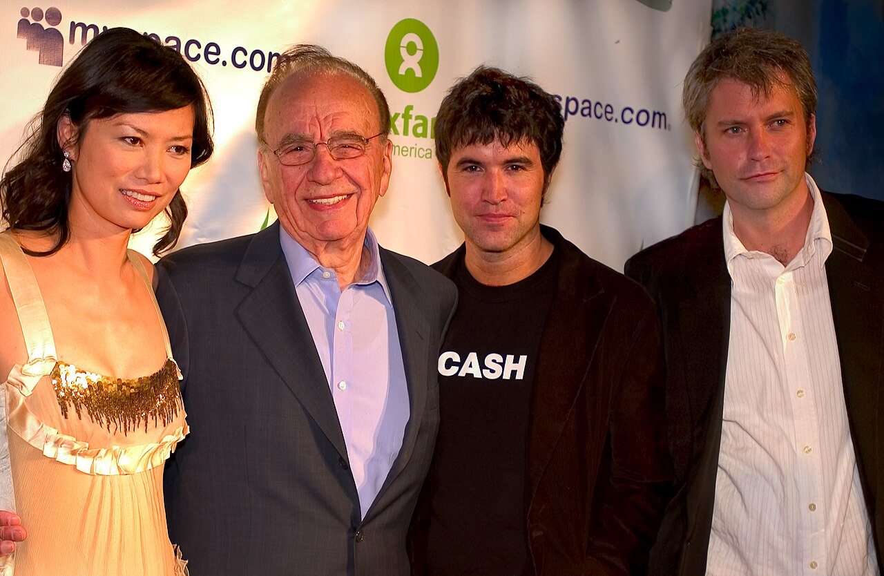Rupert Murdoch and Wendi Deng standing with MySpace co-founders Tom Anderson and Chris DeWolfe at a 2006 charity event