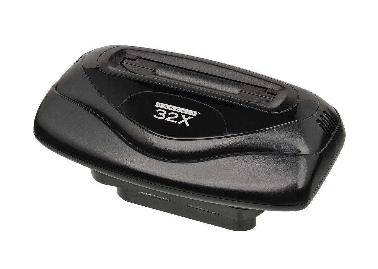 The Sega 32X, a black wedge-shaped Genesis add-on with the 32X logo on the front, photographed against a white background