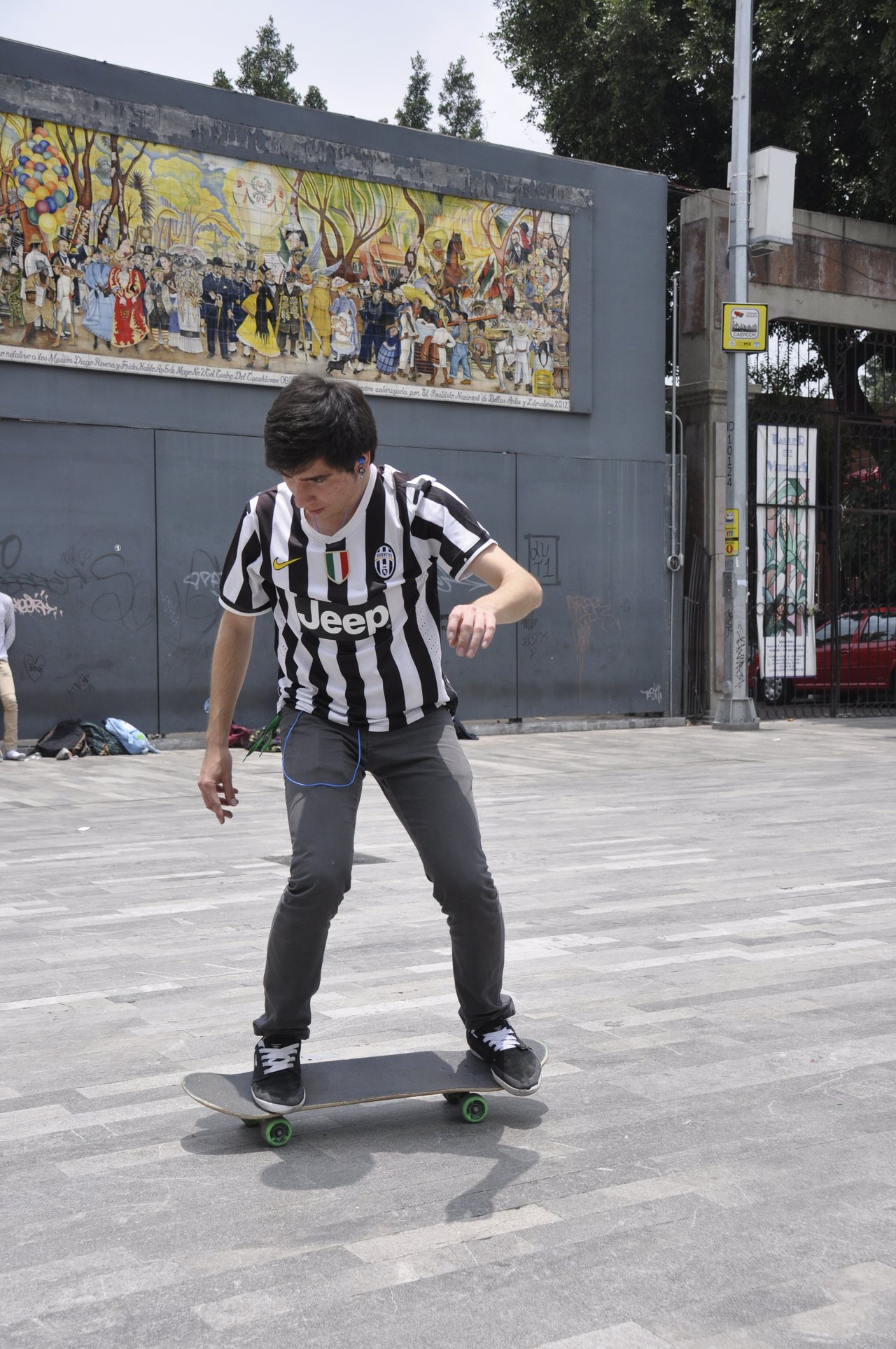 A skateboarder in mid-air performing an ollie at an outdoor skatepark