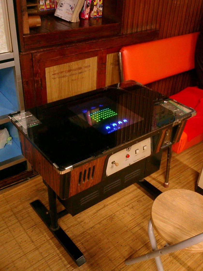 Space Invaders arcade cabinet on the floor of a Japanese game center