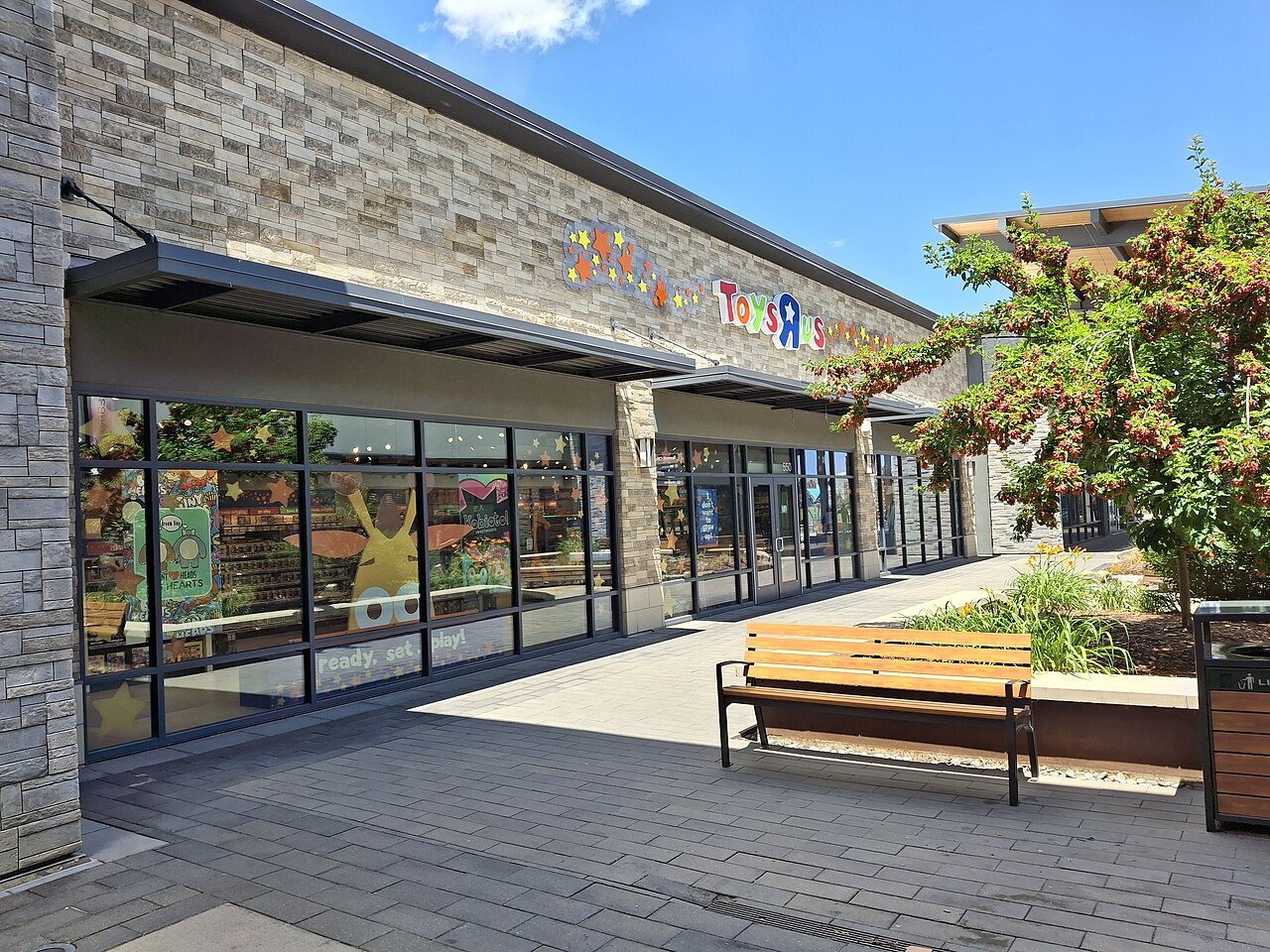Storefront of a Toys R Us shop at Denver Premium Outlets with the brand's multicolored logo above the entrance