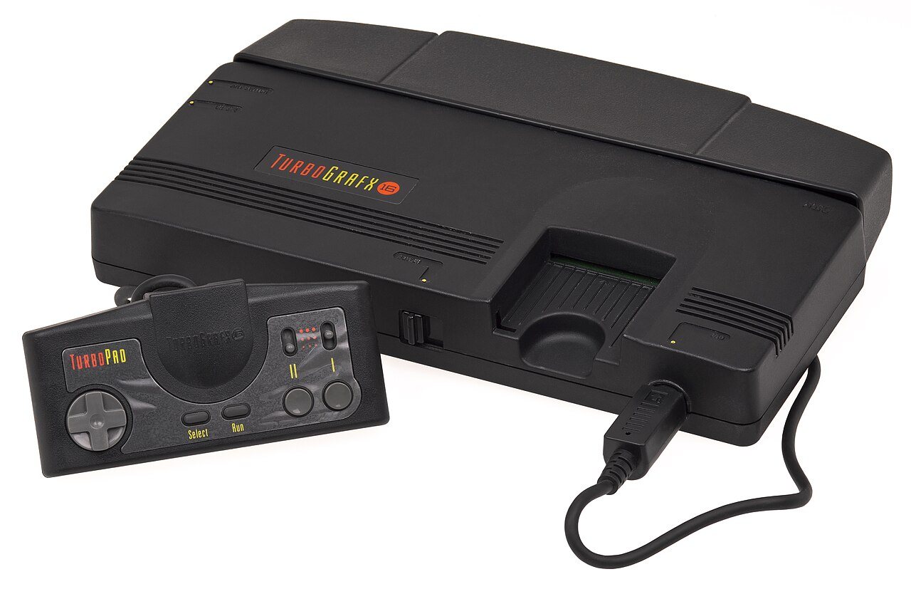 TurboGrafx-16 console in white and black with its controller and a HuCard game